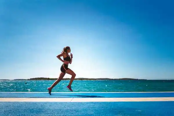 Woman running showing strong leg muscle Harrow